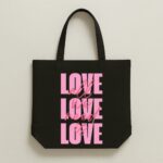 The "All We Need Is Love" Statement | Premium Black Canvas Tote bag