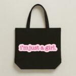 The "I'm Just A Girl" Viral Trend | Premium Black Canvas Tote bag