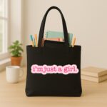 The "I'm Just A Girl" Viral Trend | Premium Black Canvas Tote bag - Image 3
